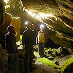 Visitors explore a cave