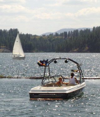 Motor boat on the lake with sailboat in the background. Motor boat on the lake with sailboat in the background.