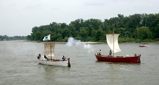 Replicas of red pirogue and white pirogue on the Missouri River in Omaha, NE.