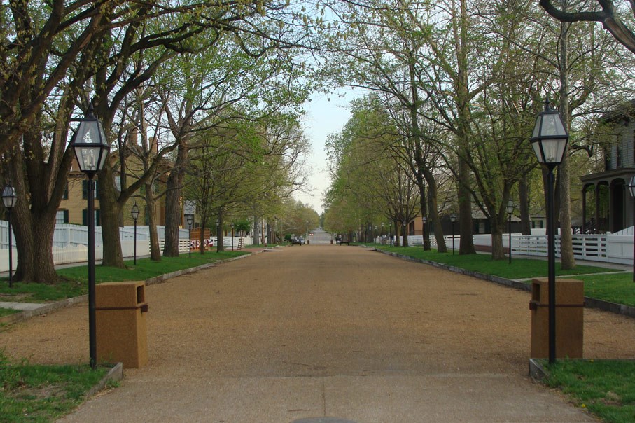 Entrance into the Lincoln Home neighborhood, gravel path lined with trees