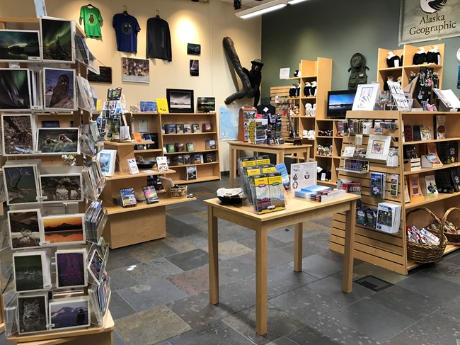 a small retail store featuring books, postcards, maps, and apparel