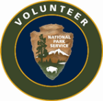 A National Park Service arrowhead with the words volunteer written above it.
