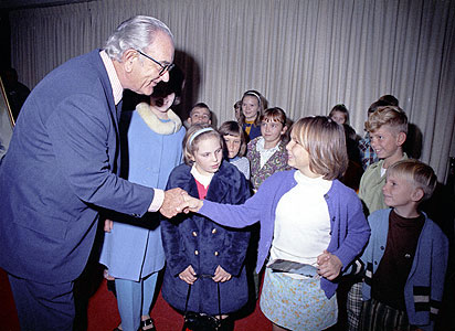 Former President Johnson shakes hands with a little girl