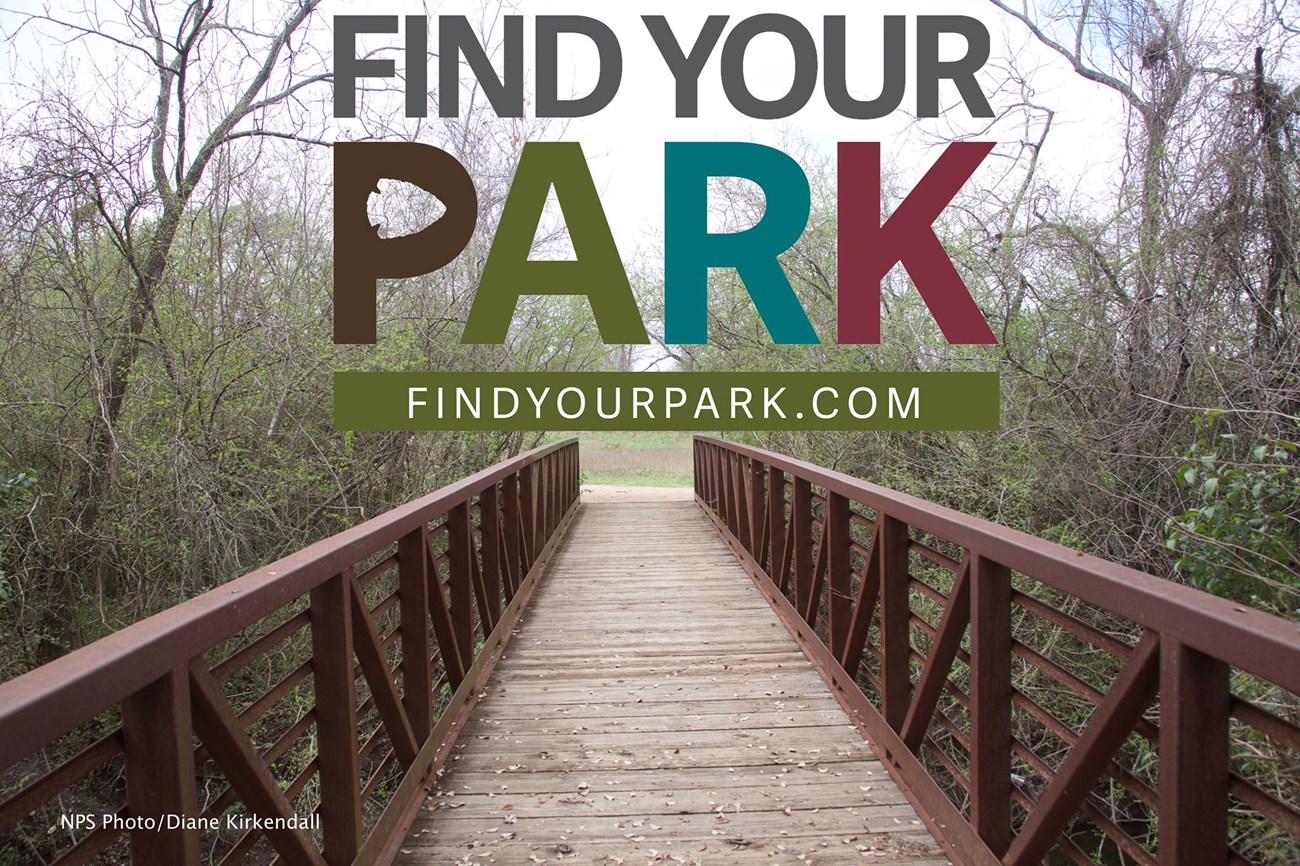 Bridge leading to the Johnson settlement with Find your park logo