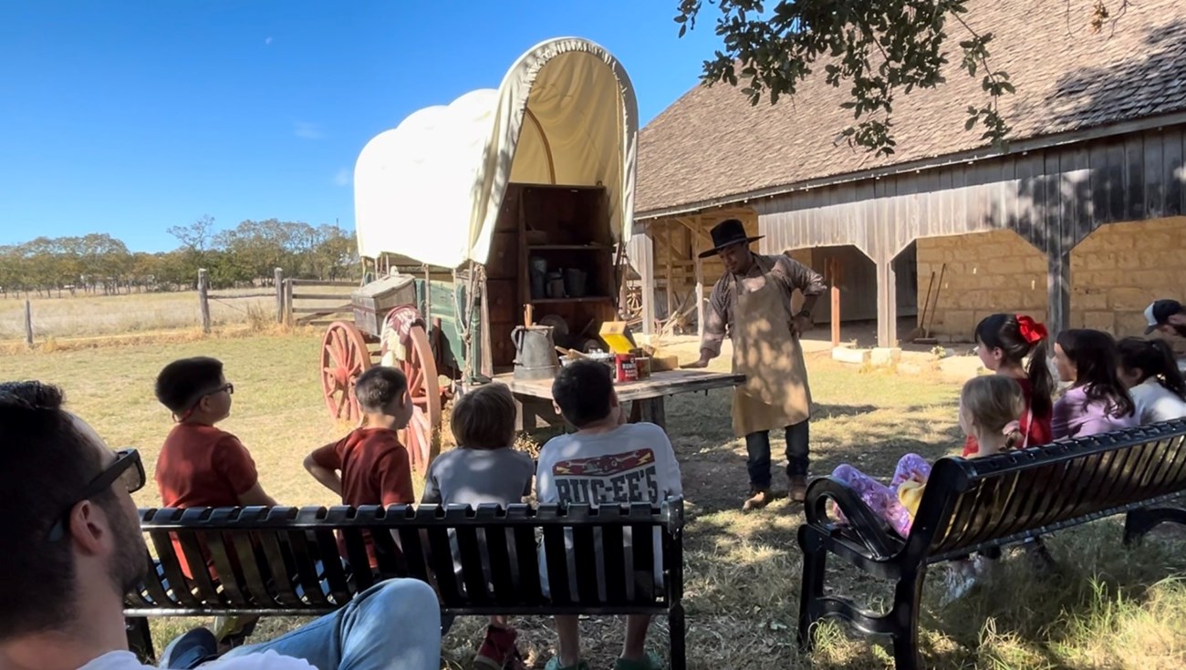 Living history Ranger teaching kids about frontier life