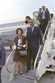 President and Mrs. Johnson leaving airplane.