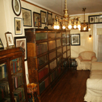 Book filled shelves and white couches in Mrs. Walker's library.