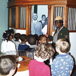 Ranger with kids in new bank exhibit.