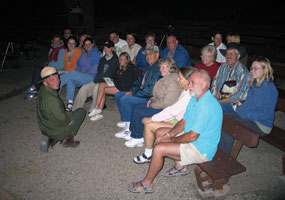 Ranger presenting an evening program to visitors in campground amphitheater.