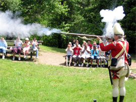 British Regular (Park Ranger) firing a musket for amazed students.