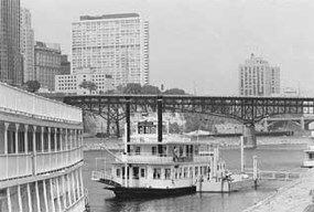 Old picture of the classic boats that set sail off the Harriet Island.