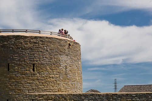Visitors approach the gate of a historic stone fort.