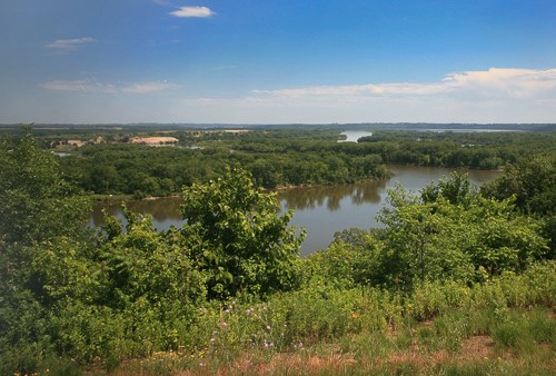 The island-dotted Mississippi River flows past forested banks and into the distance.