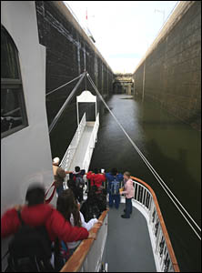 Children on an excursion boat watch their ship enter the locks.