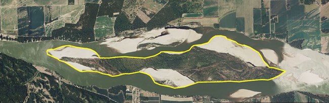 Aerial view directly over the Missouri River and Goat Island with the island outlined in yellow.