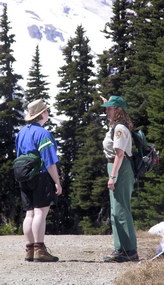 A Geologist-in-Parks volunteer assists a visitor at Sunrise