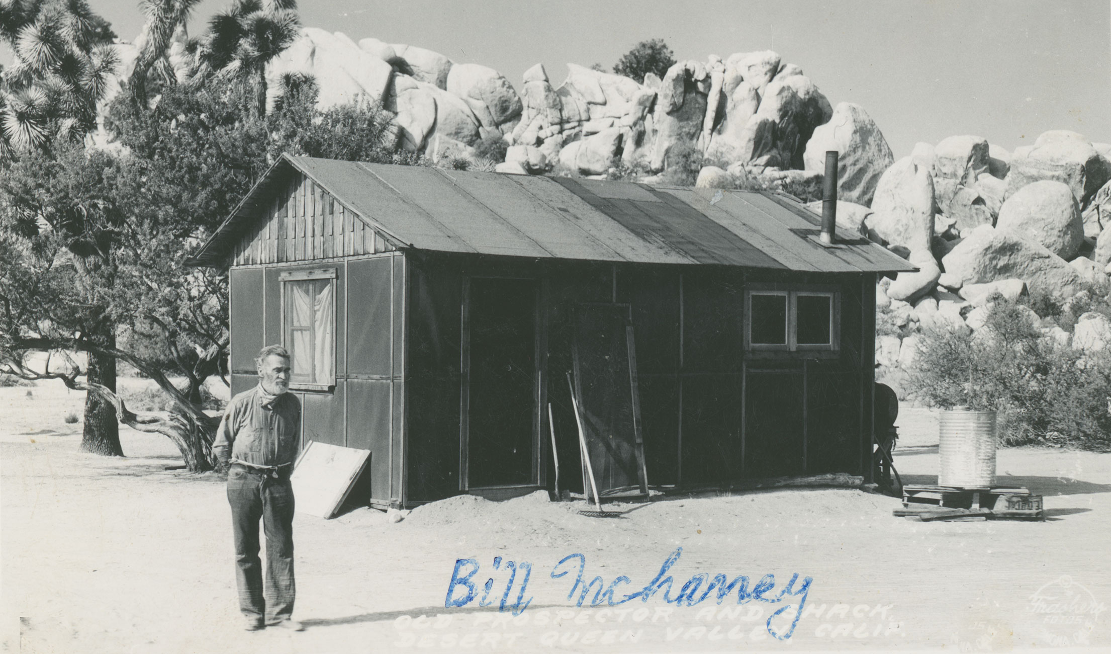(Bill McHaney in front of cabin)