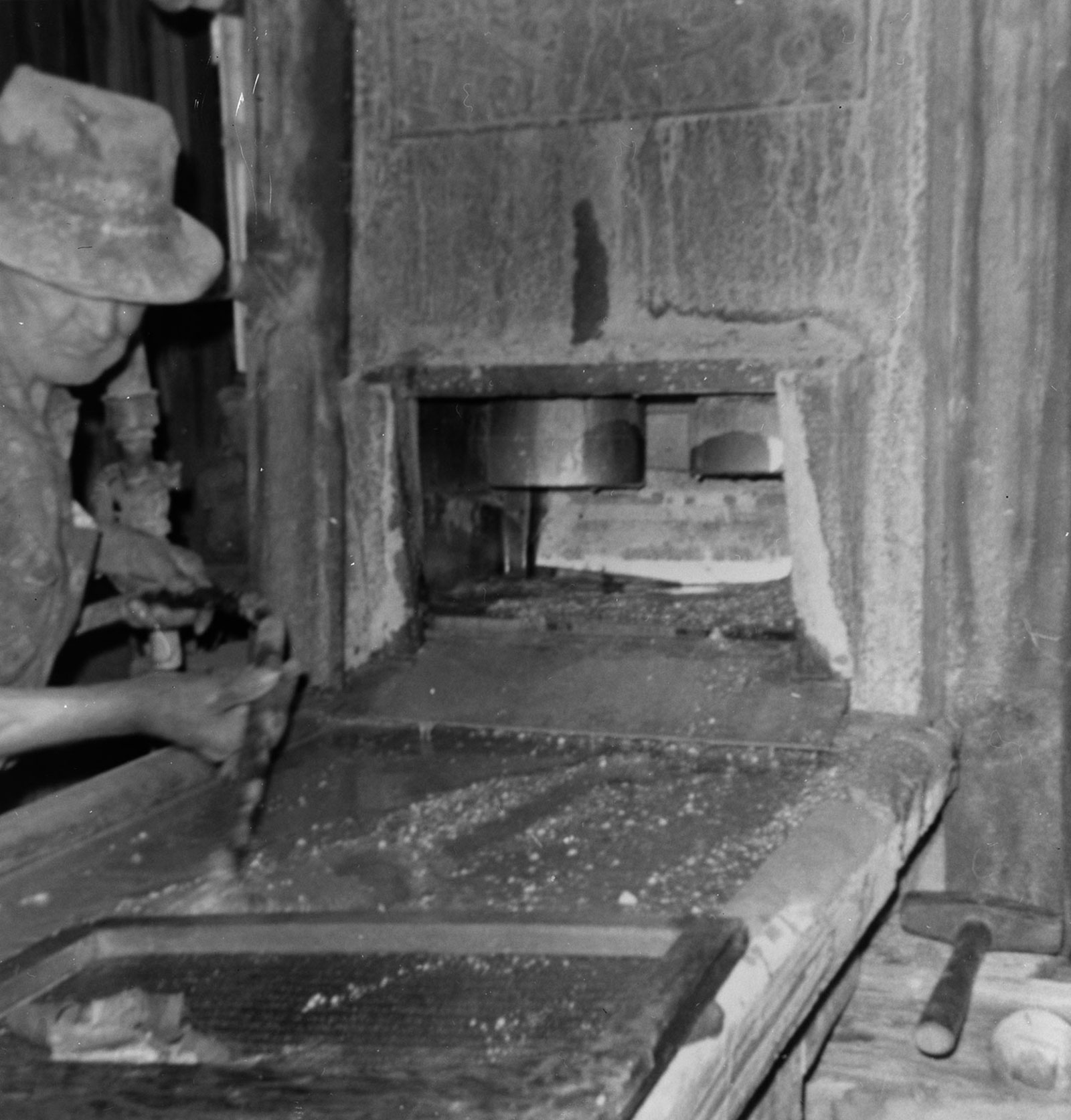Historic Photograph showing Bill Keys Cleaning Up after the Mill Run (Note Screen from Mortar Setting on Table, Stamps are Hung Up). - Wall Street Gold Mill, Twentynine Palms, San Bernardino County, CA
