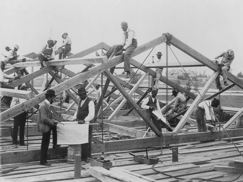 Photograph shows students of the Tuskegee Institute, Tuskegee, Alabama building a roof