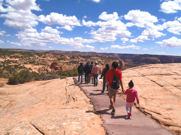 Visitors walk on the paved Sandal Trail to the Betatakin Overlook.