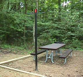 picnic table and lantern pole at campsite