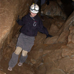 a caver scrambling down the trail during the Off-Trail Tour a caver scrambling down the trail during the Off-Trail Tour