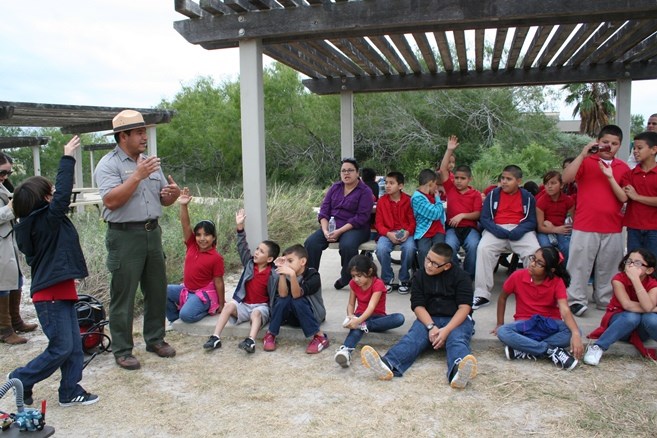 Ranger giving program to a group of middle schoolers at a picnic shelter.