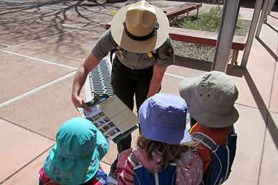 Ranger showing kids some of the park activities