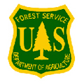 The U.S. Forest Service shield is yellow with green writing.