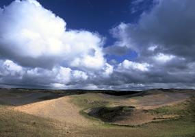 Magnificent clouds and blue sky frame the Grand Sable Dunes.