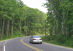 Visitor drives on a recently paved portion of Alger County Road H-58.