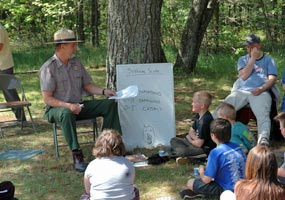 Park Ranger uses a white board to record children's ideas.