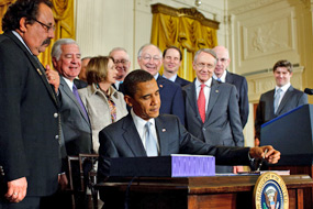 President Obama signs the Omnibus Public Lands Management Act of 2009 into law on March 30 at the White House. Also pictured from left to right: Rep. Ra&uacute;l Grijalva (D-AZ), Rep. Nick Rahall (D-WV), Speaker of the House Nancy Pelosi (D-CA), Rep. Buck McKeon (R-CA), Secretary of the Interior Ken Salazar, Senate Majority Leader Harry Reid (D-NV), Senator Ron Wyden (D-OR), and Senator Robert Bennett (R-UT) (White House Photo, 3/30/09, Chuck Kennedy)