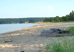 Sand Point beach on a peaceful July morning, just waiting for the afternoon heat wave, swimmers, waders, kayakers, and picnickers.