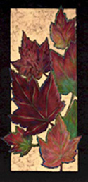 Colorful orange autumn leaves are depicted on a black mat by Artist in Residence Armstrong.