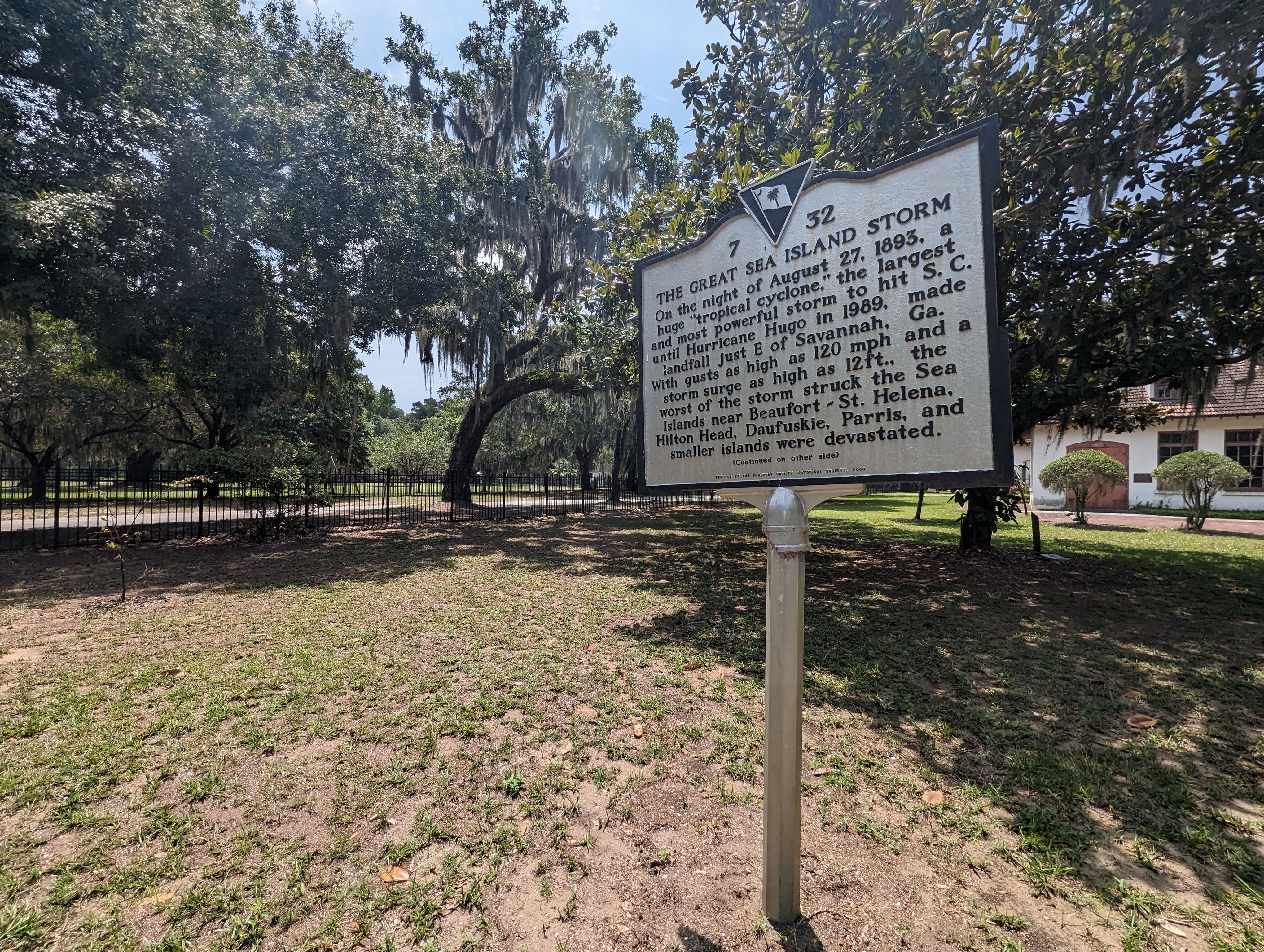 A white metal sign noting the Sea Island Hurricane of 1893