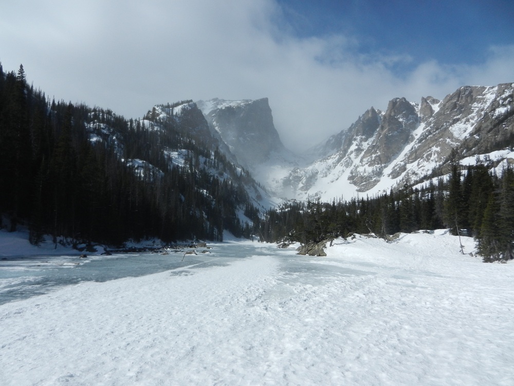 Dream Lake covered with snow on a partly cloudy day