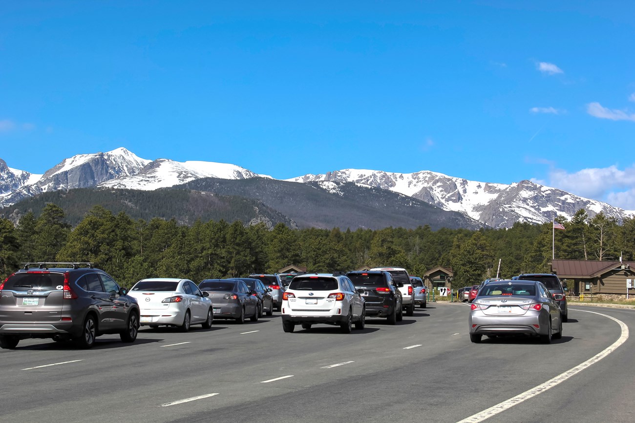 Entrance booth with cars lined up to enter a national park.