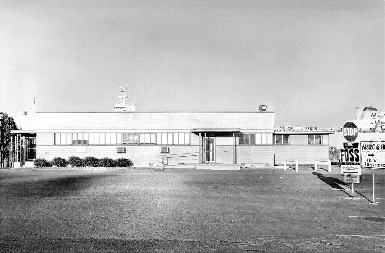 Historic black and white photo of single story building from 1940's.