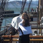 A visitor enjoying the view from the foredeck of the Balclutha.