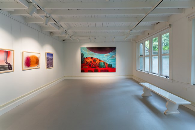 bright paintings in gallery with window