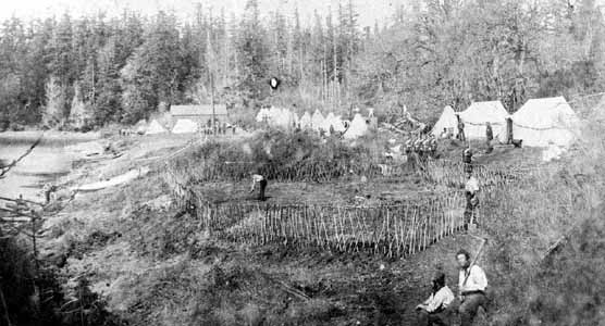 English Camp in late spring 1860 with tents on the emerging parade ground and marines working the vegetable garden..