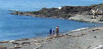 A visitor and children stroll on South Beach.