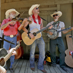 The Topanga Banjo Fiddle Contest and Music Festival is held yearly at Paramount Ranch.  In this image, a trio of players--fiddle, guitar, and banjo-- jam at the old western town movie set.