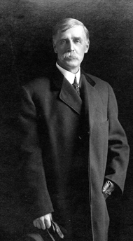 William Henry Jackson without glasses or goatee, wearing an overcoat.