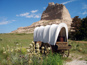 Covered wagon with Eagle Rock in the background