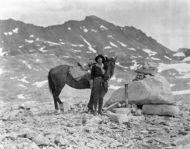 Susan Thew stands with a horse at Muir Pass