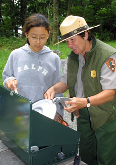 A ranger demonstrates the proper use of a campstove during a Family Camping Seminar. A ranger demonstrates the proper use of a campstove during a Family Camping Seminar.