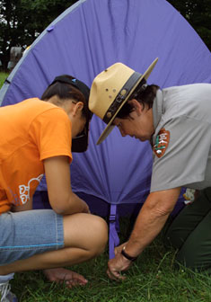 A ranger and a seminar participant pitch a tent during a Family Camping Seminar. A ranger and a seminar participant pitch a tent during a Family Camping Seminar.