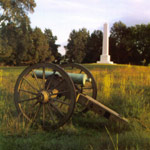 Cannon in front of a whitle onelisk monument.